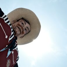 a man wearing a hat and a red jacket