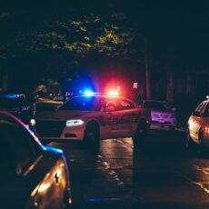 A couple of police cars parked in a parking lot