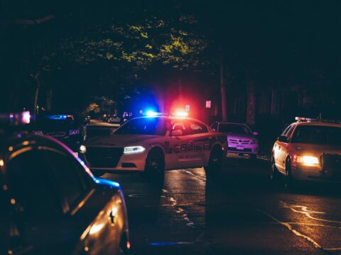 A couple of police cars parked in a parking lot